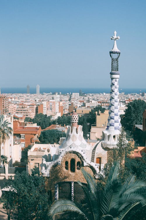 Surrealistic architecture of towers and gardens against modern cityscape in sunny summer day in Spain