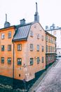 From above corner of aged residential three levels house with shabby walls located on narrow uneven street in old town