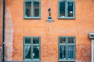 Old red residential house with grey windows frames