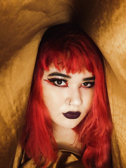 Stylish woman with bright makeup and colorful hair