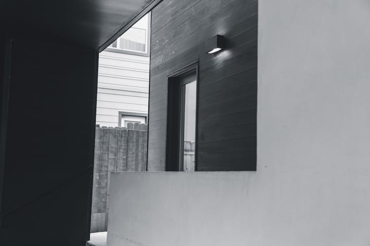 Wall Mounted Lamp Near Door In Yard Of Modern House