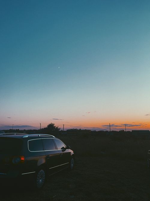 Free Bright colorful sundown over silhouettes of forest and parked car in rural landscape Stock Photo