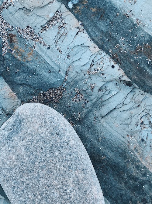 Top view of abstract background of frozen ice surface under stone in daylight