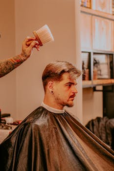 A young man gets a stylish haircut in a contemporary salon.
