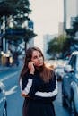 Pensive young woman walking on city street