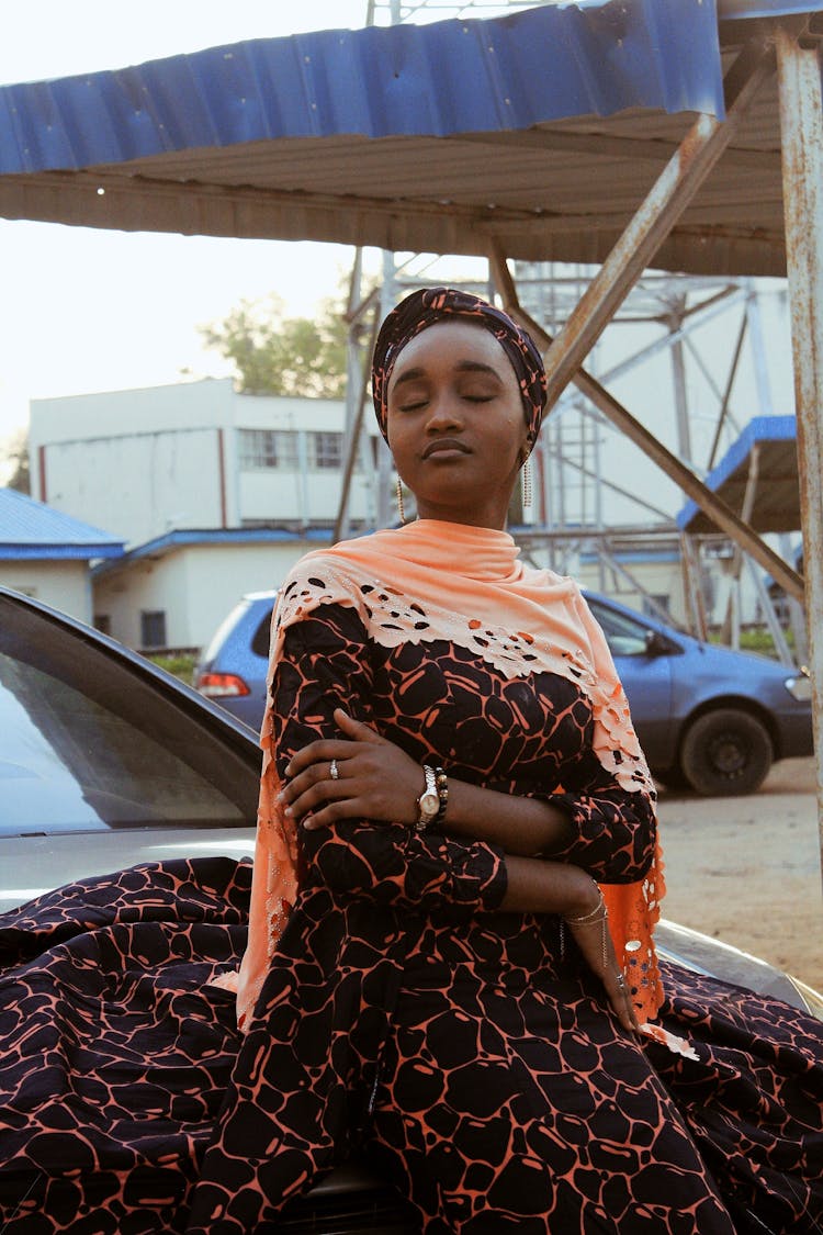 Dreamy Black Woman In Long Dress On Car