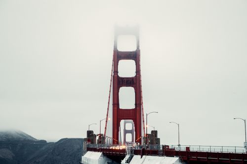 Free Iconic view of Golden Gate Bridge enveloped in clouds, showcasing its majestic structure. Stock Photo