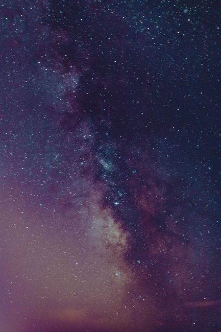 From below abstract backdrop of picturesque purple sky with tiny stars in twilight