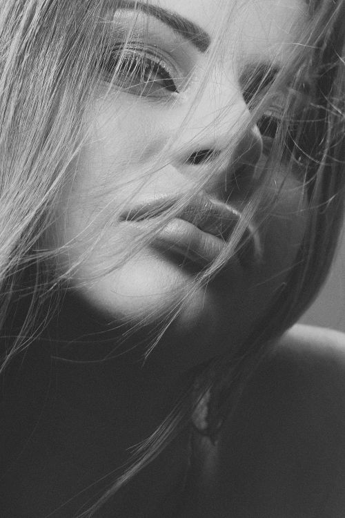 Free Artistic grayscale portrait of a woman with soft lighting and expressive eyes. Stock Photo