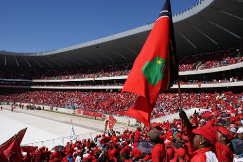 A Stadium Filled with People Wearing Red Shirts 