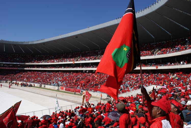 A Stadium Filled With People Wearing Red Shirts 