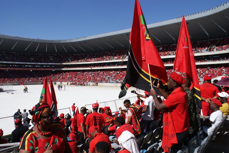 People In The Stadium Holding Red Flags 