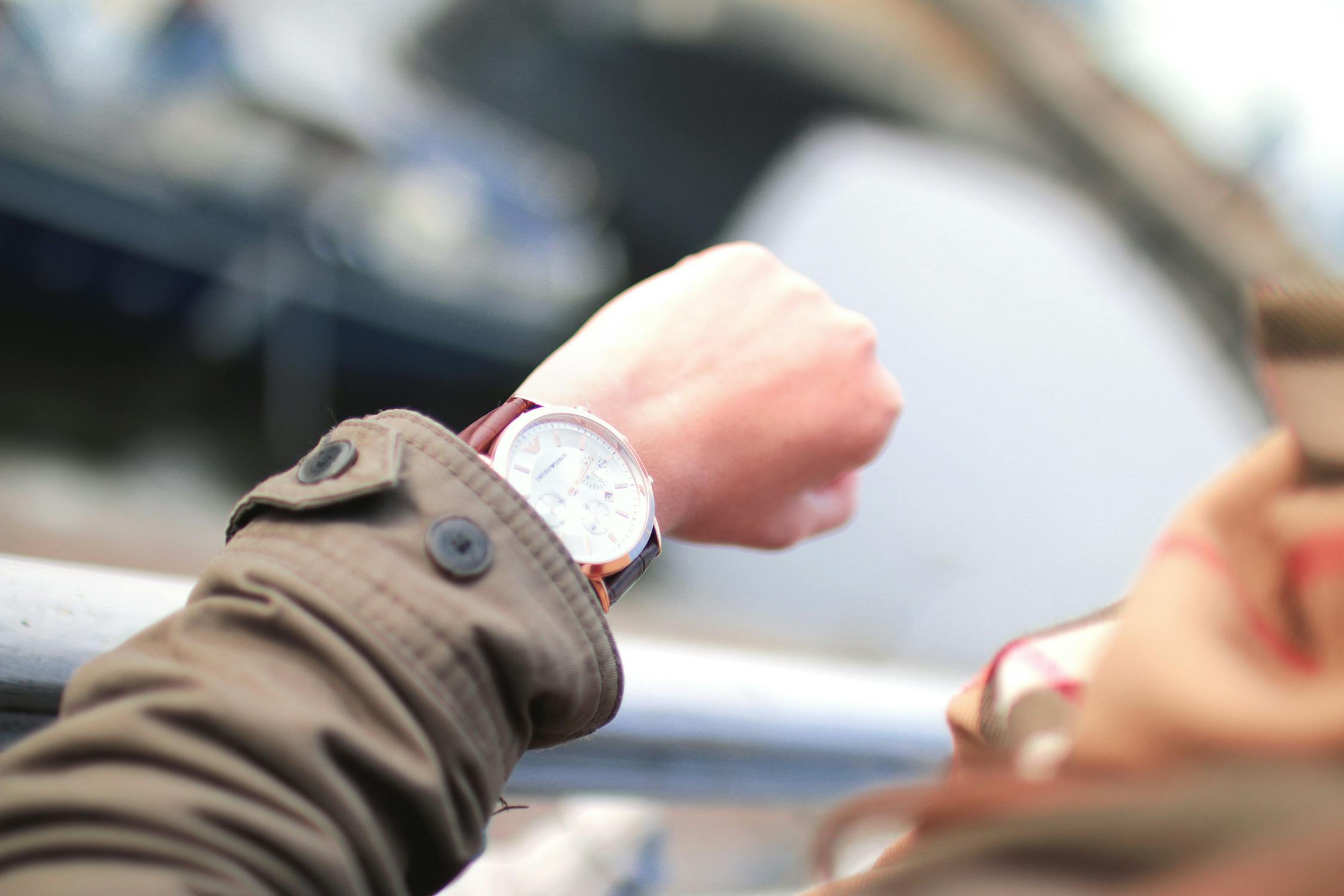 A man checking the time on his watch.