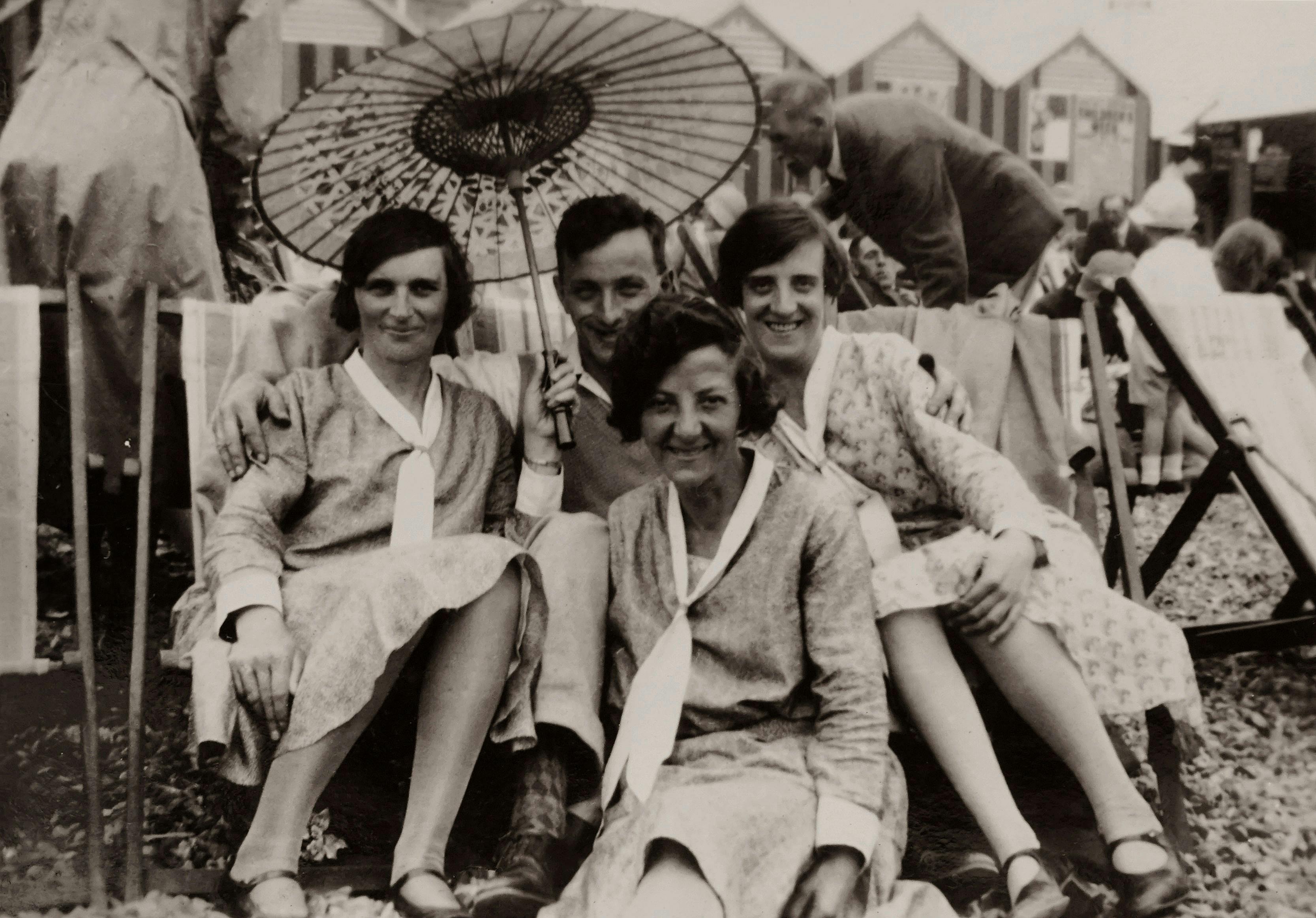 Classic black and white photo of smiling adults during a summer vacation.