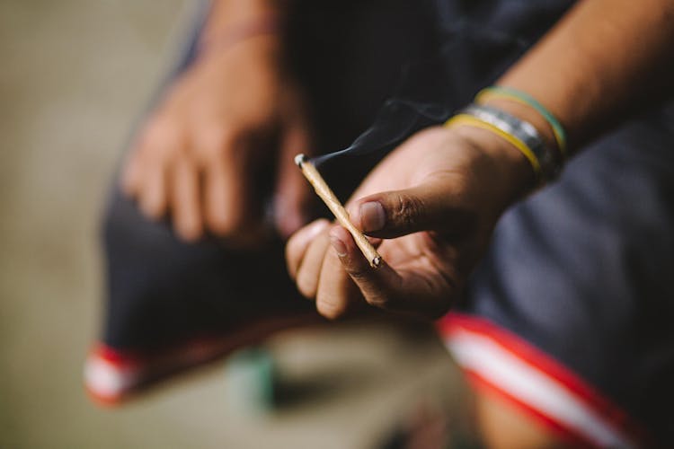 Person Holding A Cigarillo