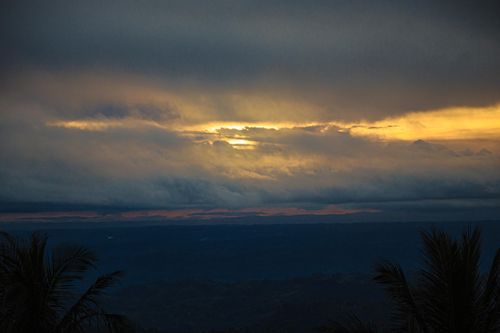 Free Stunning sunset with dramatic clouds and golden hour hues captured over a scenic landscape. Stock Photo