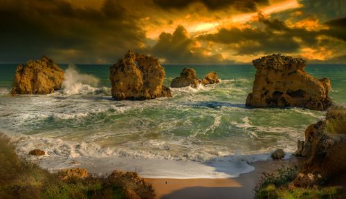 Free Captivating sunset over ocean waves and rock formations, creating a dramatic coastal landscape. Stock Photo