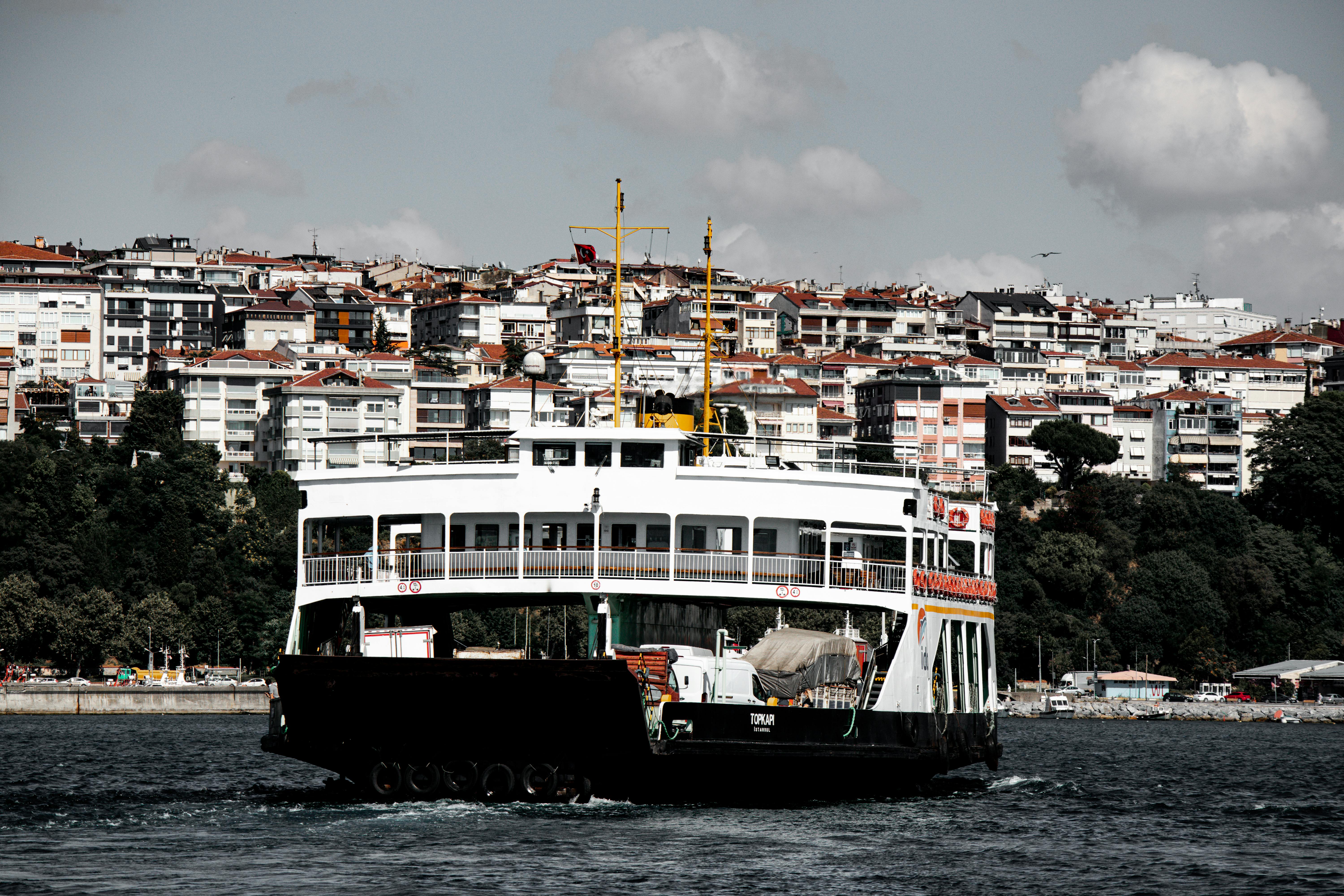 Free Ferry cruising on the Bosphorus with Istanbul's urban backdrop. Iconic cityscape and historic transport. Stock Photo