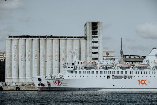 Piri Reis University ship docked in İstanbul, Türkiye, with a backdrop of industrial structures.
