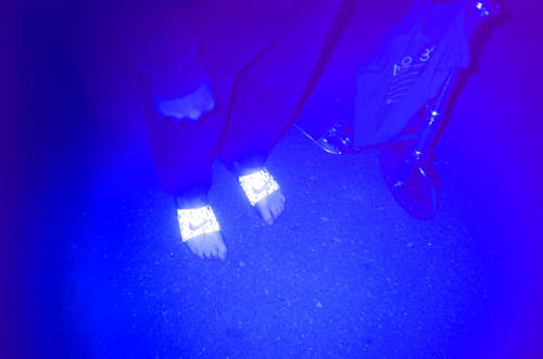 Person in slippers in ultraviolet illumination