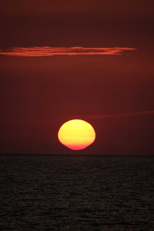 Amazing bright sunset over wavy sea