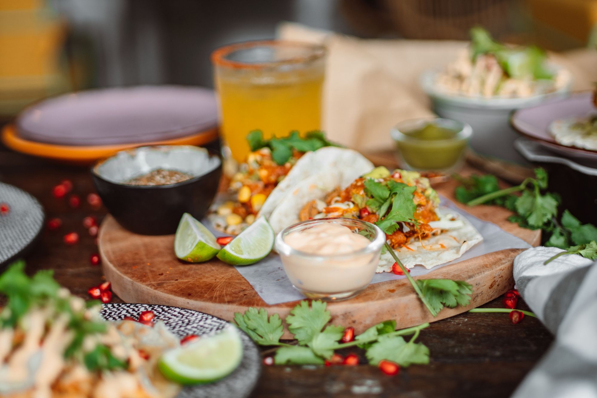Corn tortillas, lime and fresh salsa on a rustic wooden table, traditional Yucatecan cooking
