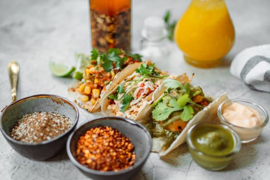 Close-up of Mexican tacos with diverse fillings, spices, and sauces, perfect for food lovers.