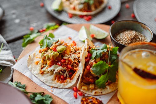 Free Delicious Mexican street tacos served with fresh ingredients and a citrus beverage. Stock Photo