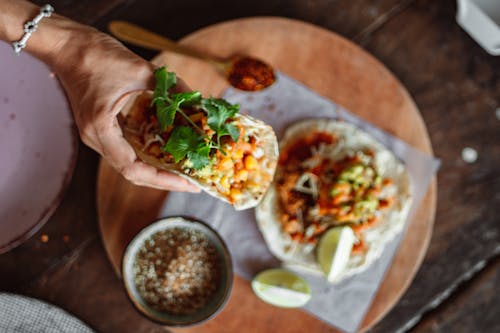 Free A Person Holding a Taco Stock Photo