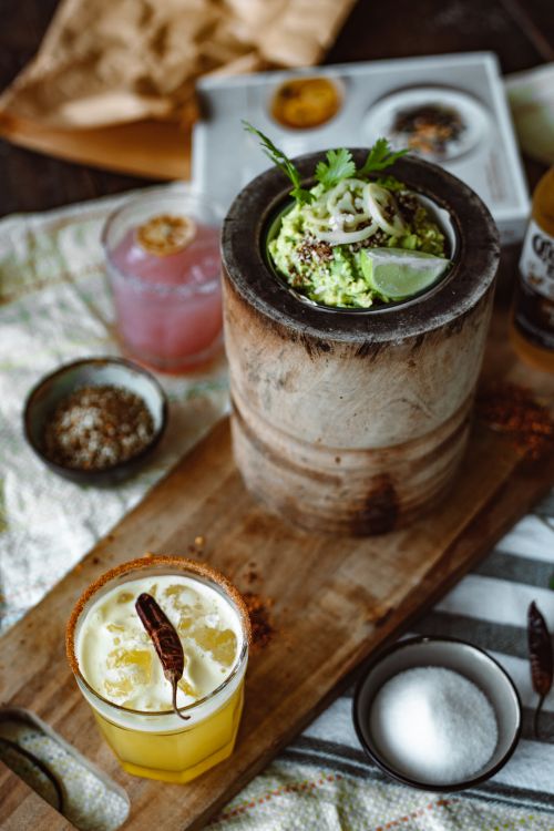 Free Inviting rustic brunch featuring citrus and herb garnished dishes and drinks on a wooden table. Stock Photo