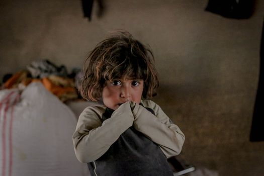 Scared kid looking at camera