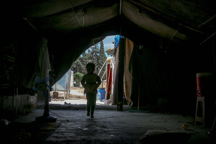 Unrecognizable Child Walking In Tent