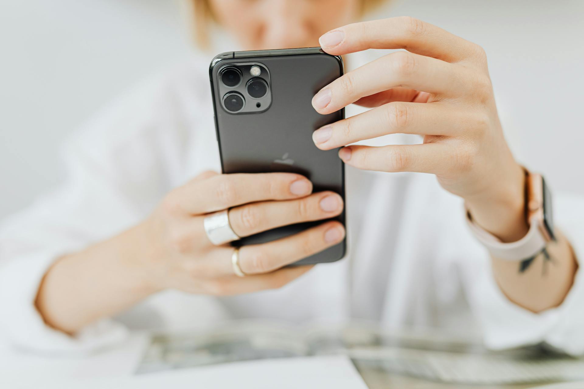 A close-up of a person holding a smartphone indoors, showcasing modern technology and connectivity.