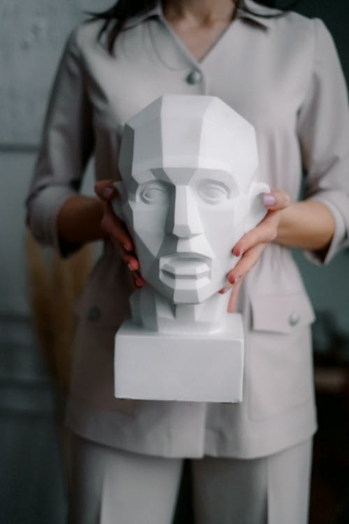 Photo Of Person Carrying A Sculpture On Her Hands