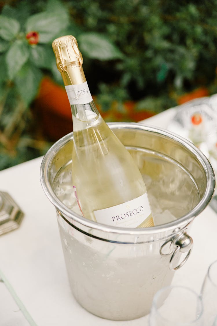 Champagne Bottle In Ice Bucket On Banquet Table