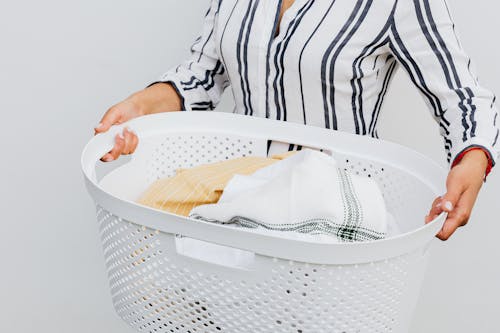 Free Close-up of Woman Holding Basket with Laundry Stock Photo