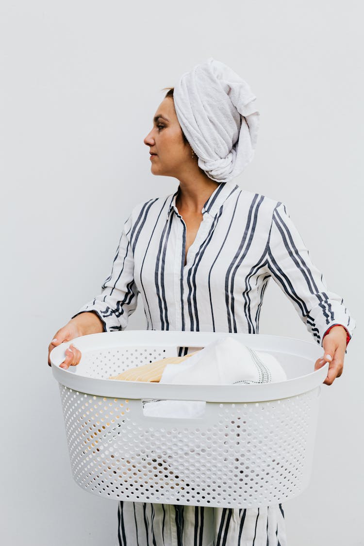 Photo Of A Woman Holding A Laundry Basket