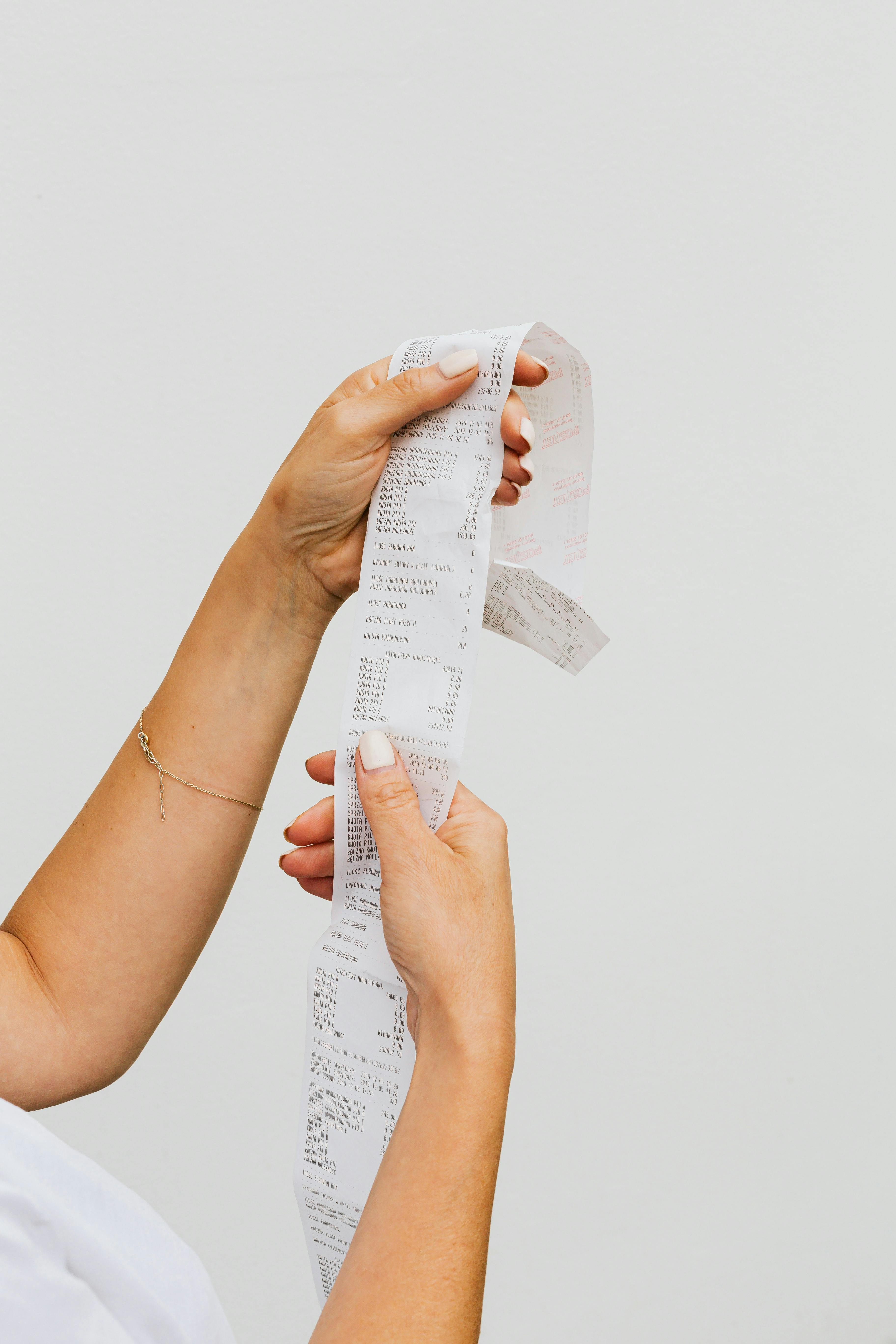 close up of woman hands holding bill