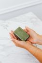 Woman Holding a Bar of Soap in her Hands
