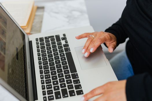 Close-up of hands typing on a laptop, ideal for tech and lifestyle themes.