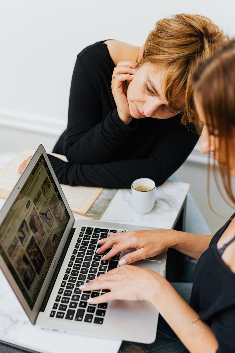 Women Looking At Images On Laptop Screen