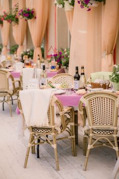 Interior of stylish restaurant with wooden decorated tables and chairs in spacious space
