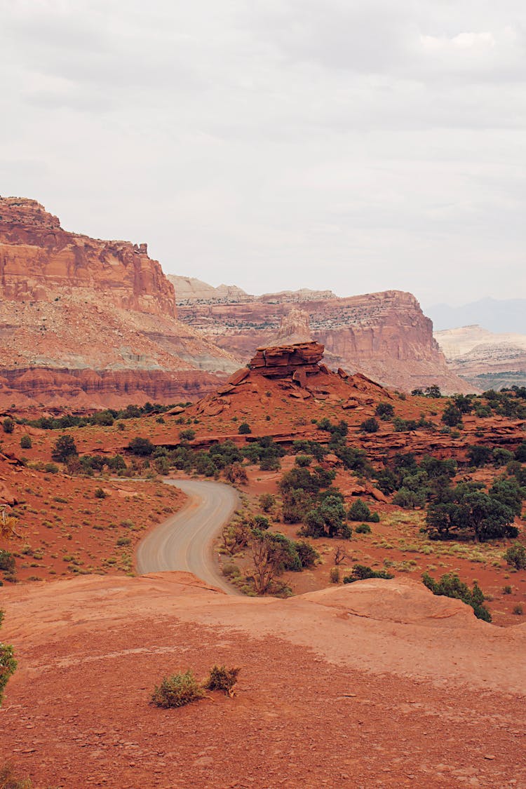 Curved Road Near Brown Rocky Mountains