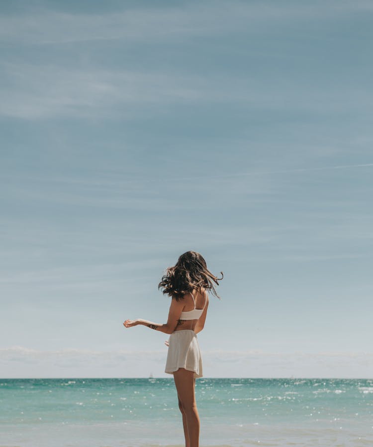 Young Woman Enjoying Summer Day On Beach