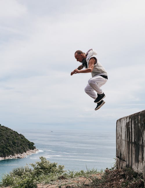 Free A Man Jumping from the Wall Stock Photo