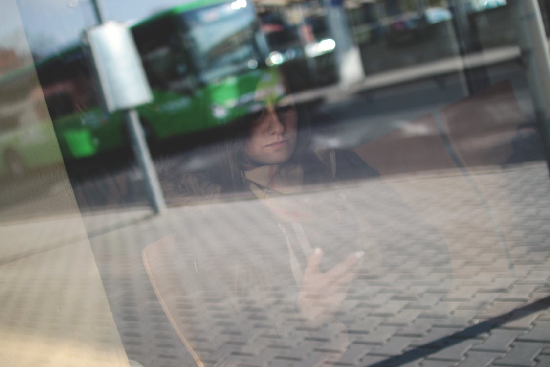 Woman Sitting on Chair Holding Phone