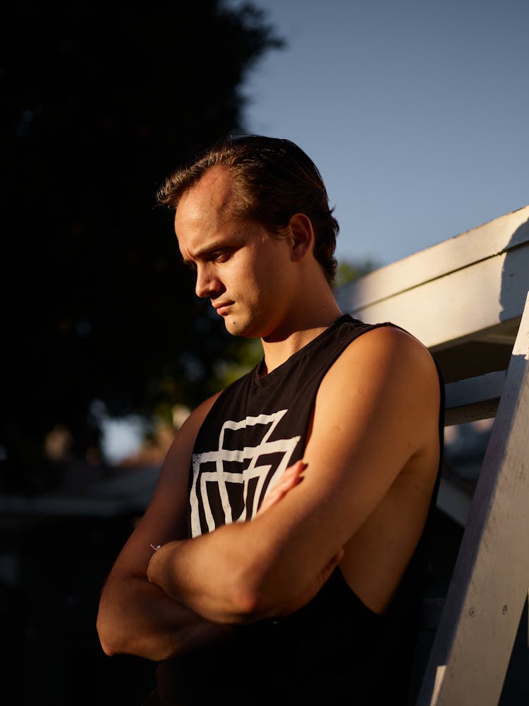 A Man In Black Sleeveless Shirt With Arms Folded