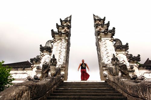 Free A man stands at the historic Pura Lempuyang Luhur Temple in Bali, showcasing traditional culture and architecture. Stock Photo