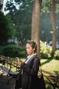 Woman in Black Blazer Sitting on Bench