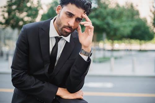 Free Photo of a Man in a Black Suit with His Hand on His Head Stock Photo